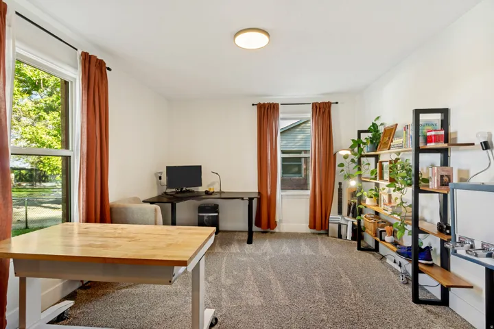Recessed ceiling lighting, two large windows, and wall-to-wall carpeting