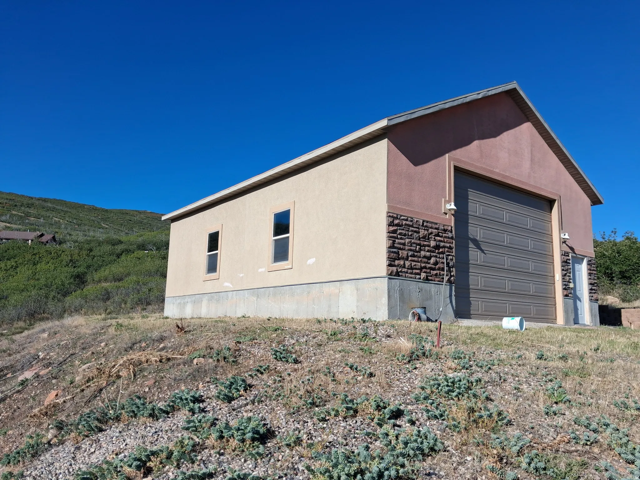 Detached structure featuring stucco and stone veneer exterior