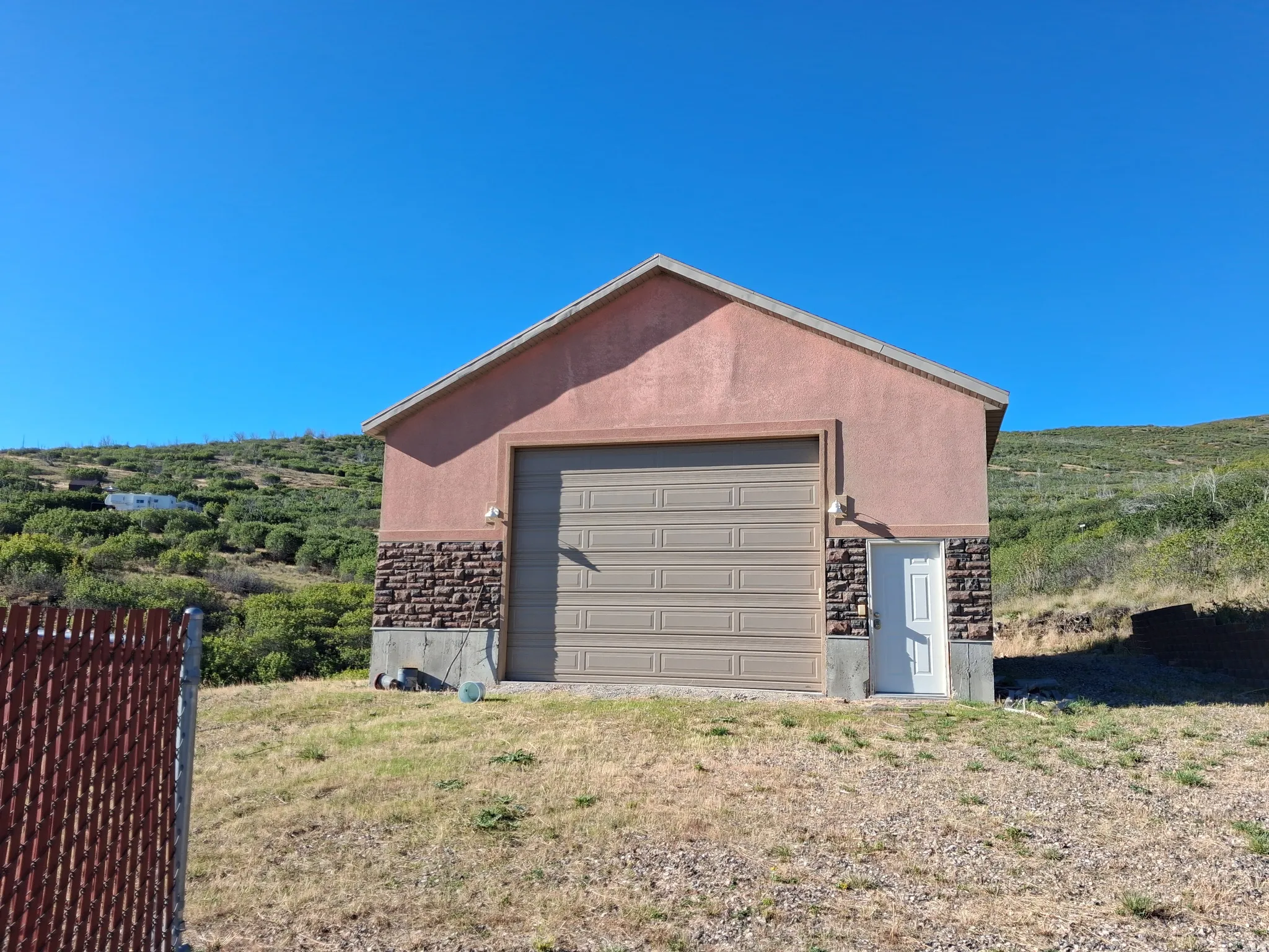 Gable roof structure with stucco siding and stone veneer accents