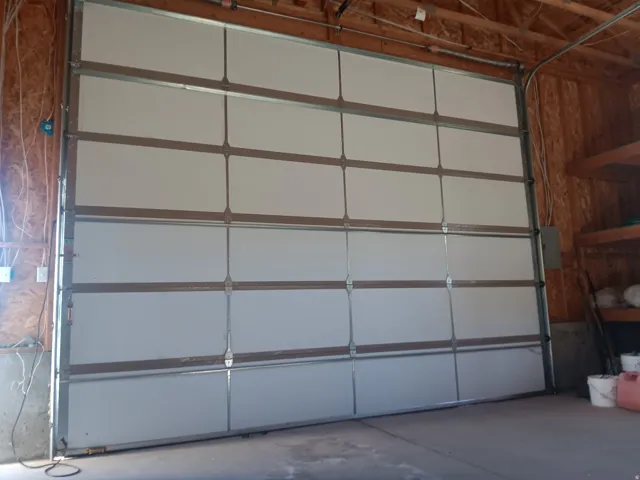 White sectional garage door with metal tracking system