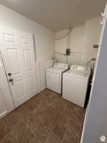Dedicated laundry area with tile flooring and a panel door