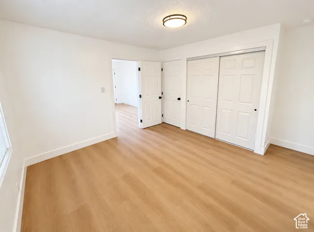 Wood-finish flooring, white walls, and white trim