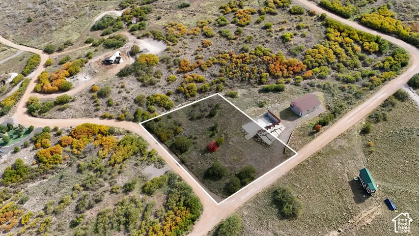 G-48 to be sold w/ property.  Aerial perspective of a lot featuring an existing structure, a paved driveway, and established native vegetation