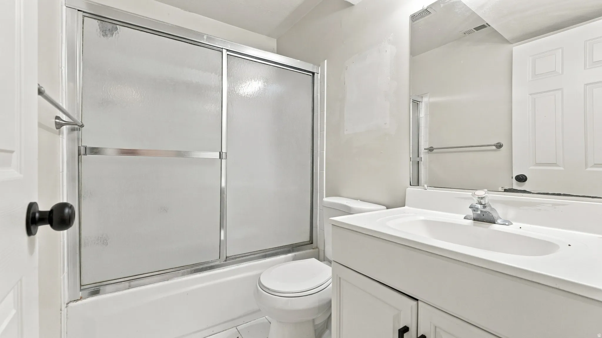 White vanity with a single basin sink and chrome faucet