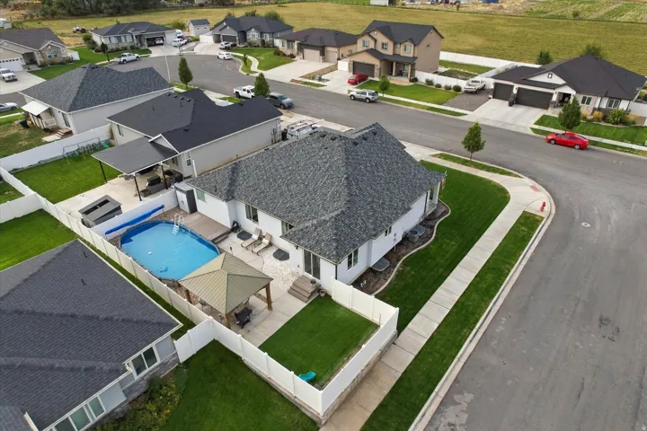 Modern residence showcasing a resort-style backyard with sparkling in-ground swimming pool, spa, and expansive patio area