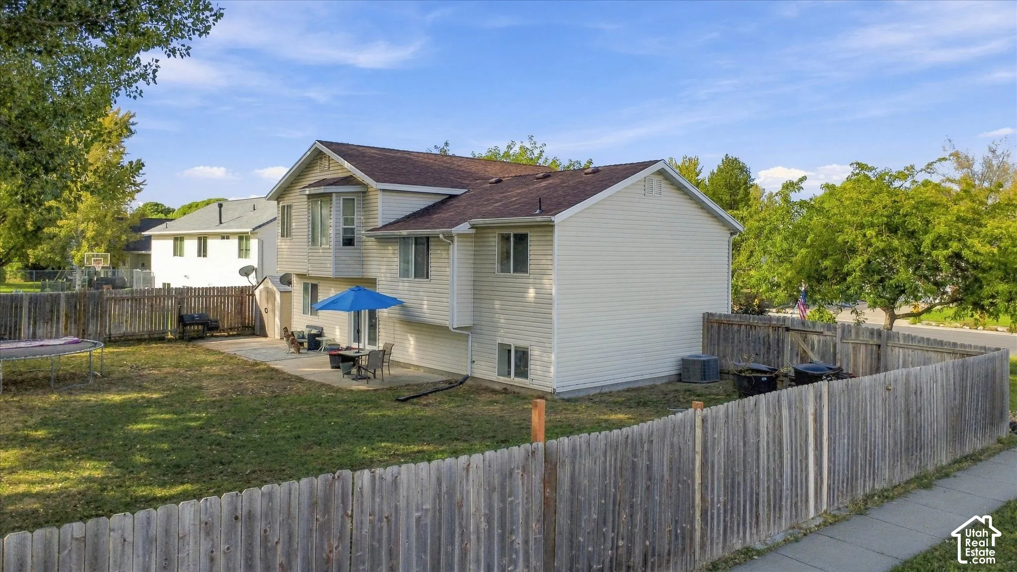 Siding exterior with a bay window feature, a patio area, and a fenced backyard