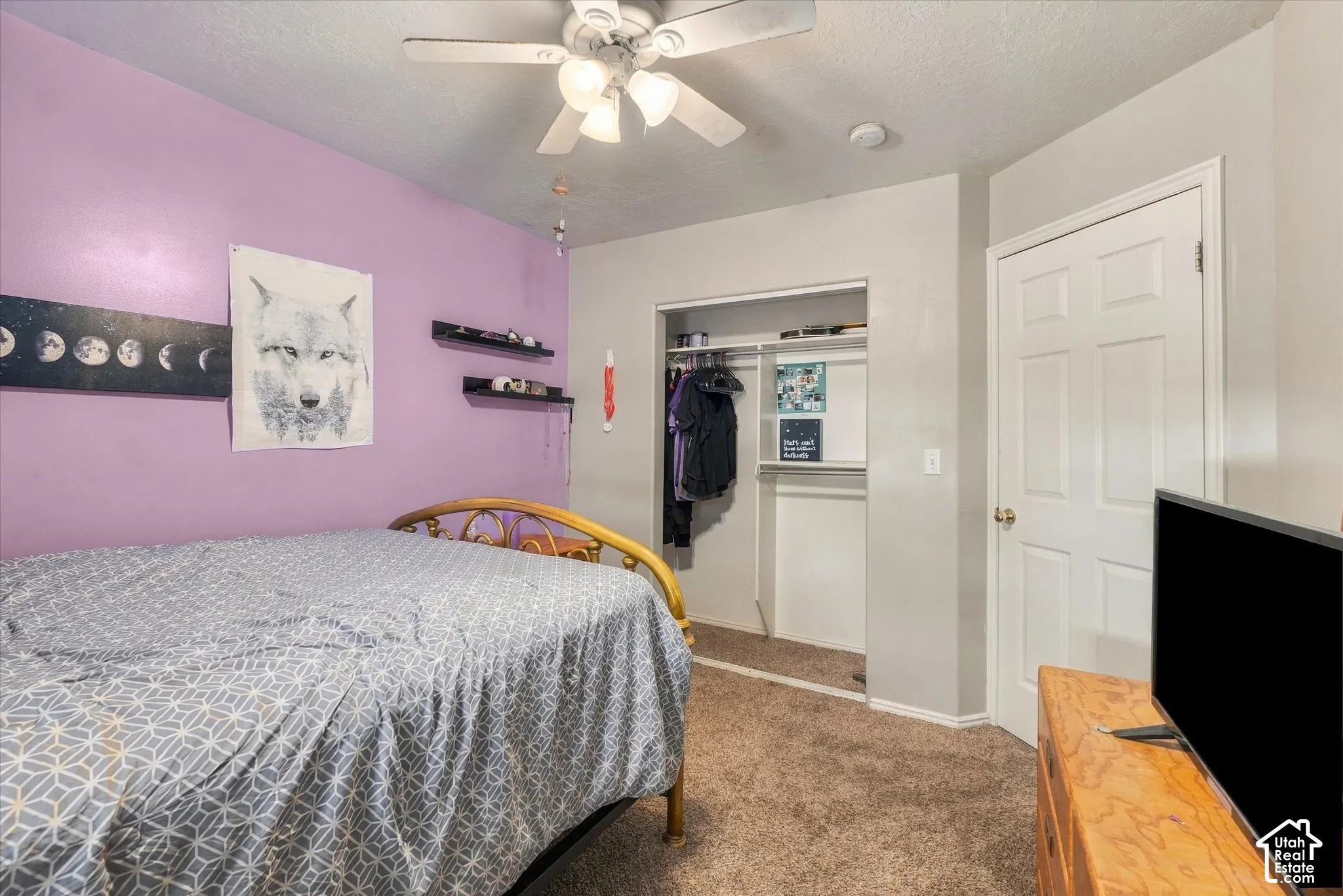 Recessed ceiling fan with integrated lighting, wall-to-wall carpeting, open closet with hanging rod, and a six-panel door