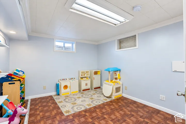 Bedroom 5. Recessed lighting, wood-finish flooring, white crown molding, and two windows provide natural light