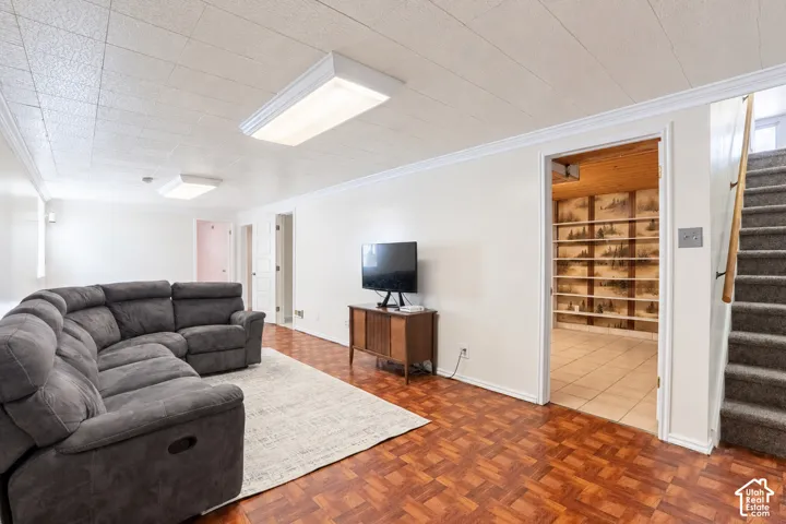 Recessed ceiling with flush mount lighting, patterned wood-finish flooring, and white wall finishes