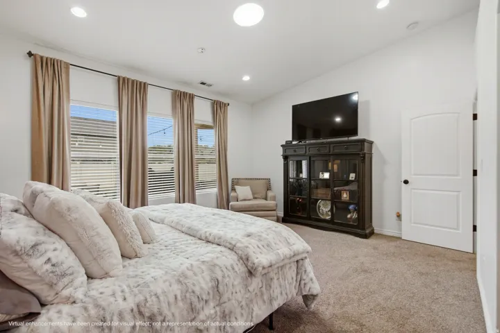 Vaulted ceilings, recessed lighting, arched interior door, and multiple windows with blinds