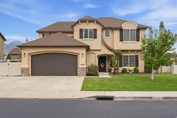 Stucco exterior with stone accents and a multi-level roofline