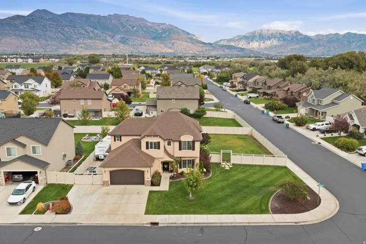 Two-story residence with a stucco exterior, a large attached two-car garage, and a concrete driveway