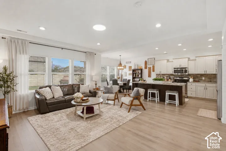 Open-concept living space with wood-finish flooring