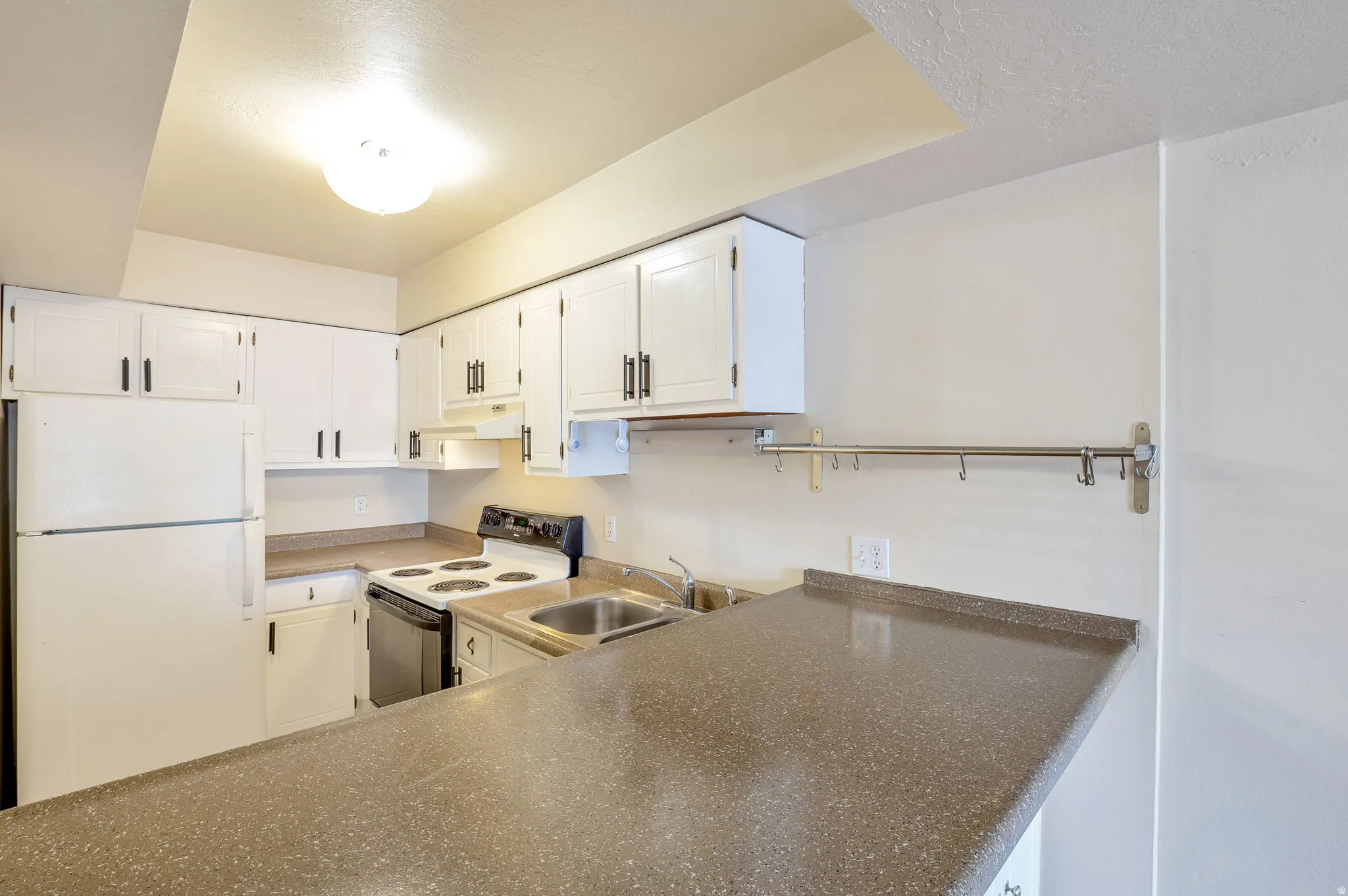 Kitchen Featuring White Cabinetry and a Breakfast Bar