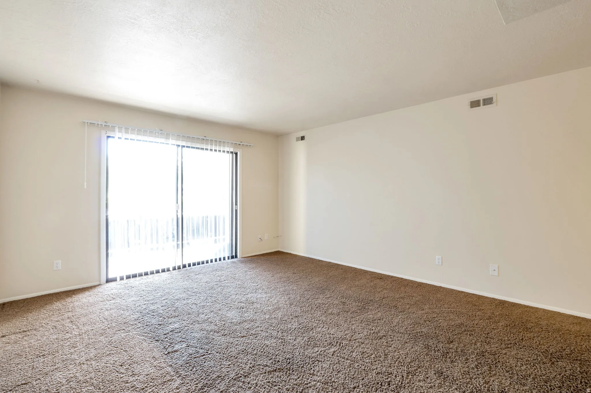 Living Room with Sliding Glass Doors Leading Out to Balcony