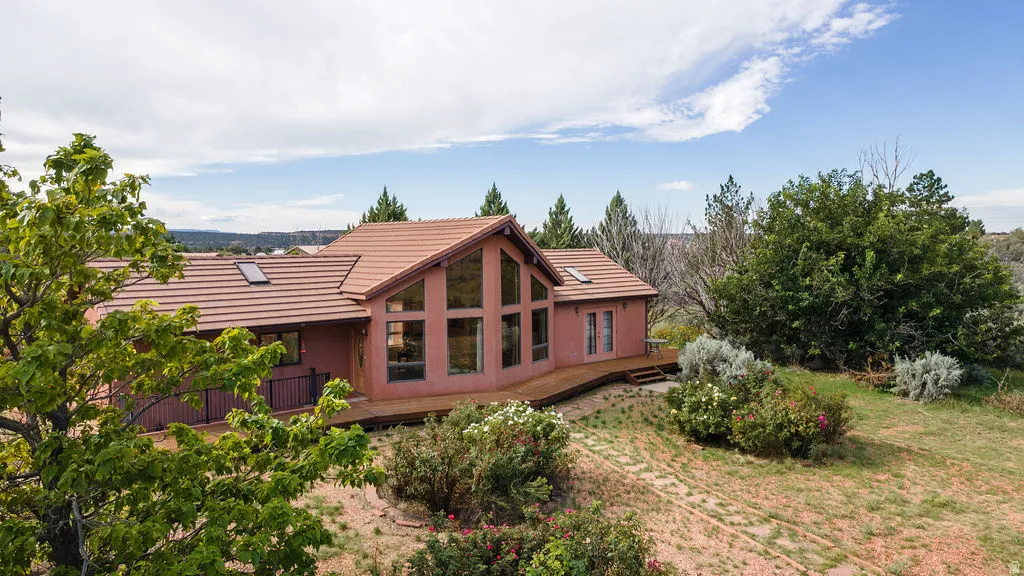 Contemporary residence featuring a distinctive pitched metal roof with copper-toned finish, complemented by warm terracotta exterior siding