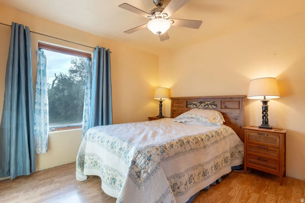 Wood-finish flooring with a ceiling fan light fixture