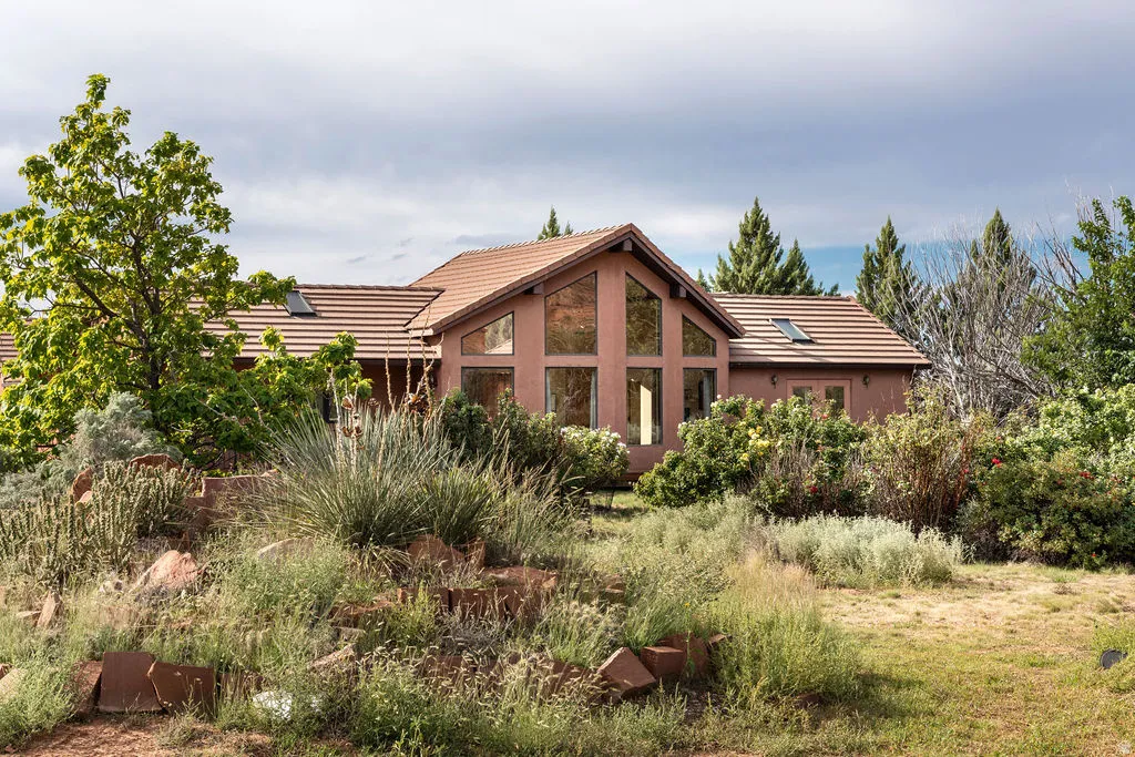 Terracotta exterior with a peaked roof, expansive window wall, and skylights
