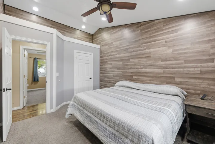 Master Bedroom. Accent wall featuring horizontal wood-finish paneling