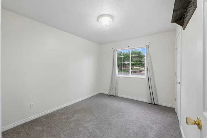 Recessed window, white trim, grey carpet flooring, white walls, flush mount ceiling light fixture