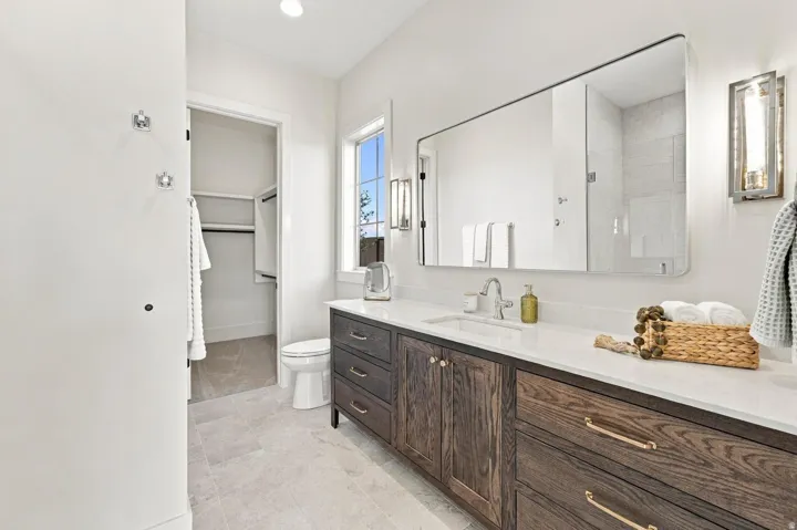 Dark wood-finish vanity with a white countertop and rectangular undermount sink