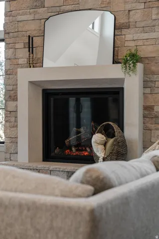 Stacked stone fireplace surround with a white mantle and hearth