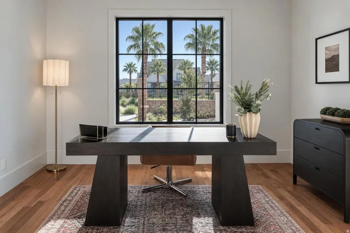 Hardwood flooring, white walls, and a black-framed window with grilles