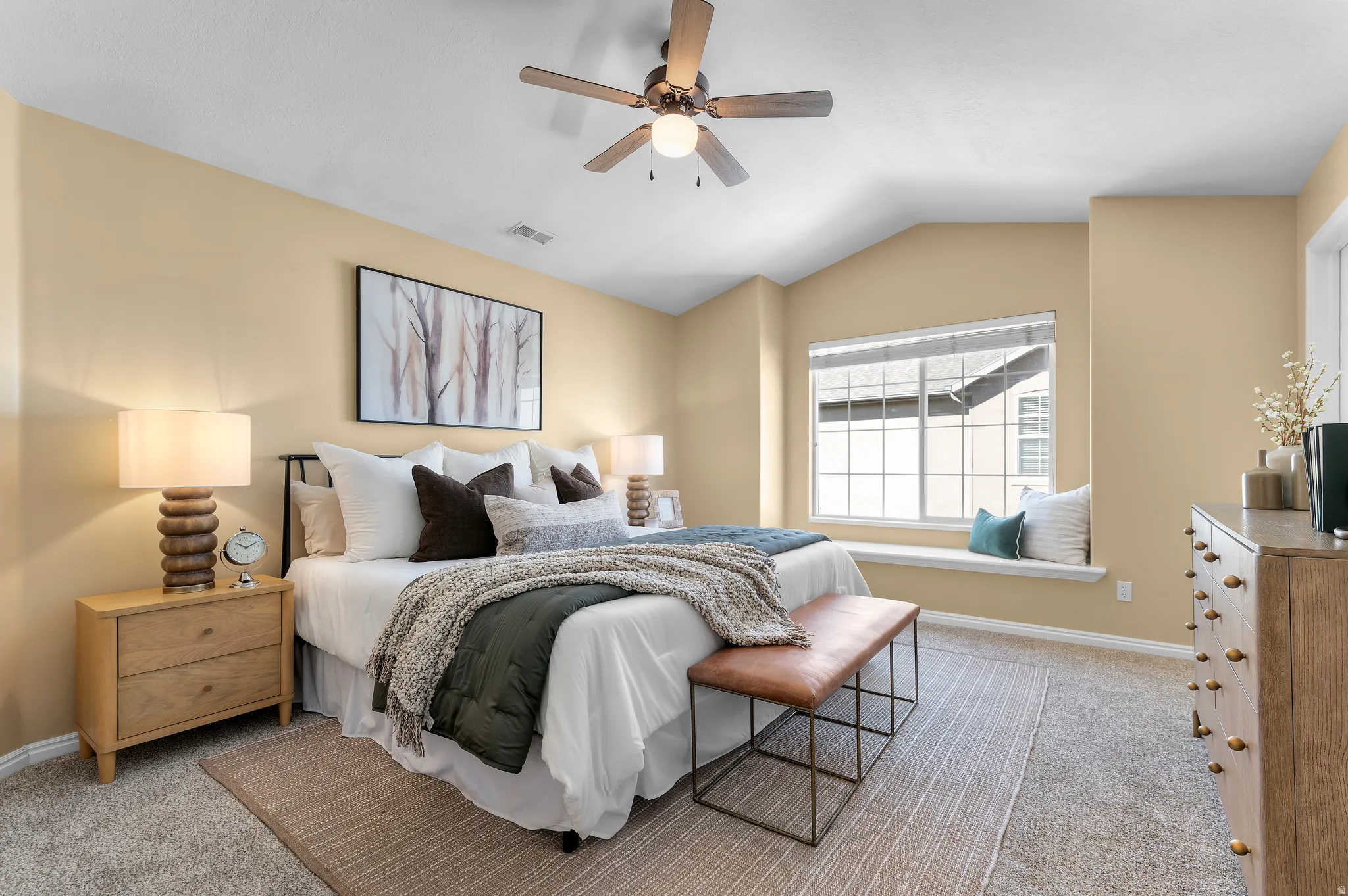 Primary Bedroom with vaulted ceilings, a built-in window seat, and brand new ceiling fan with integrated lighting