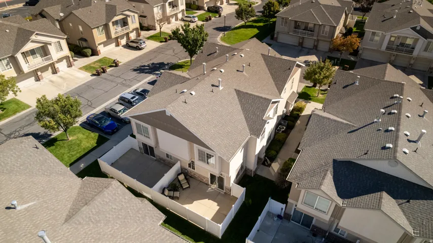 Aerial perspective of a residential community featuring townhomes with asphalt shingle roofs