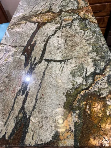 Polished natural stone surface featuring varied veining and organic color patterns