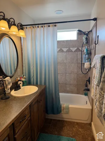 Vanity with a built-in sink, wood-finish cabinetry, and a countertop