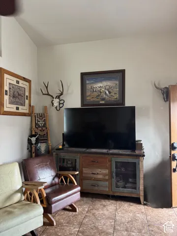 Recessed wall niche, tiled flooring, and a solid wood door with black hardware