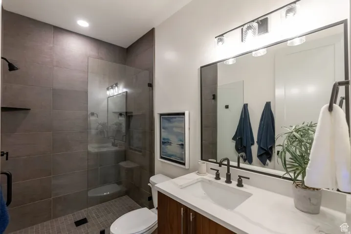 Walk-in shower with full-height tile surround and glass enclosure