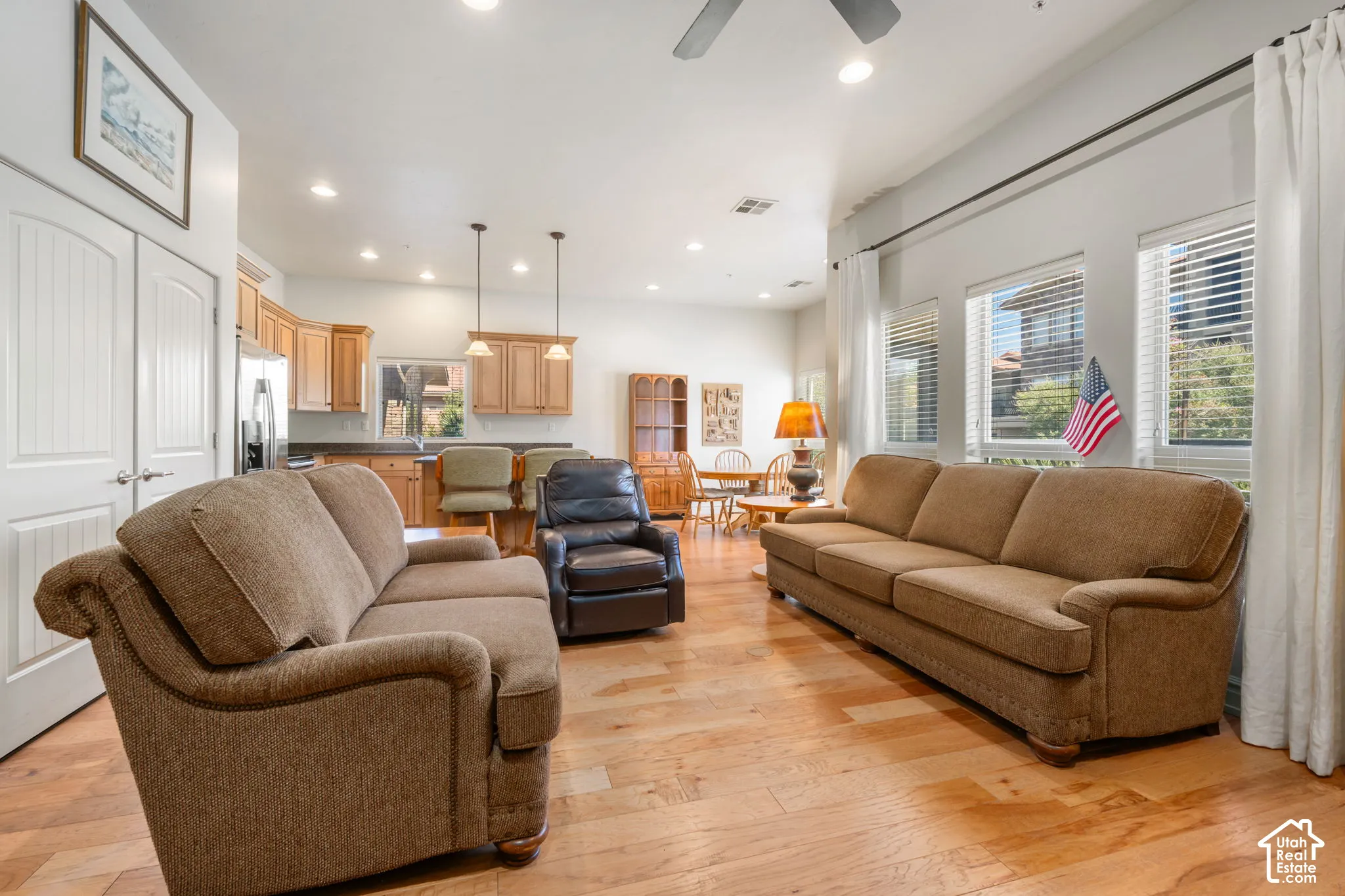 Hardwood flooring, recessed lighting, white interior doors, wood cabinetry, and stainless steel appliances