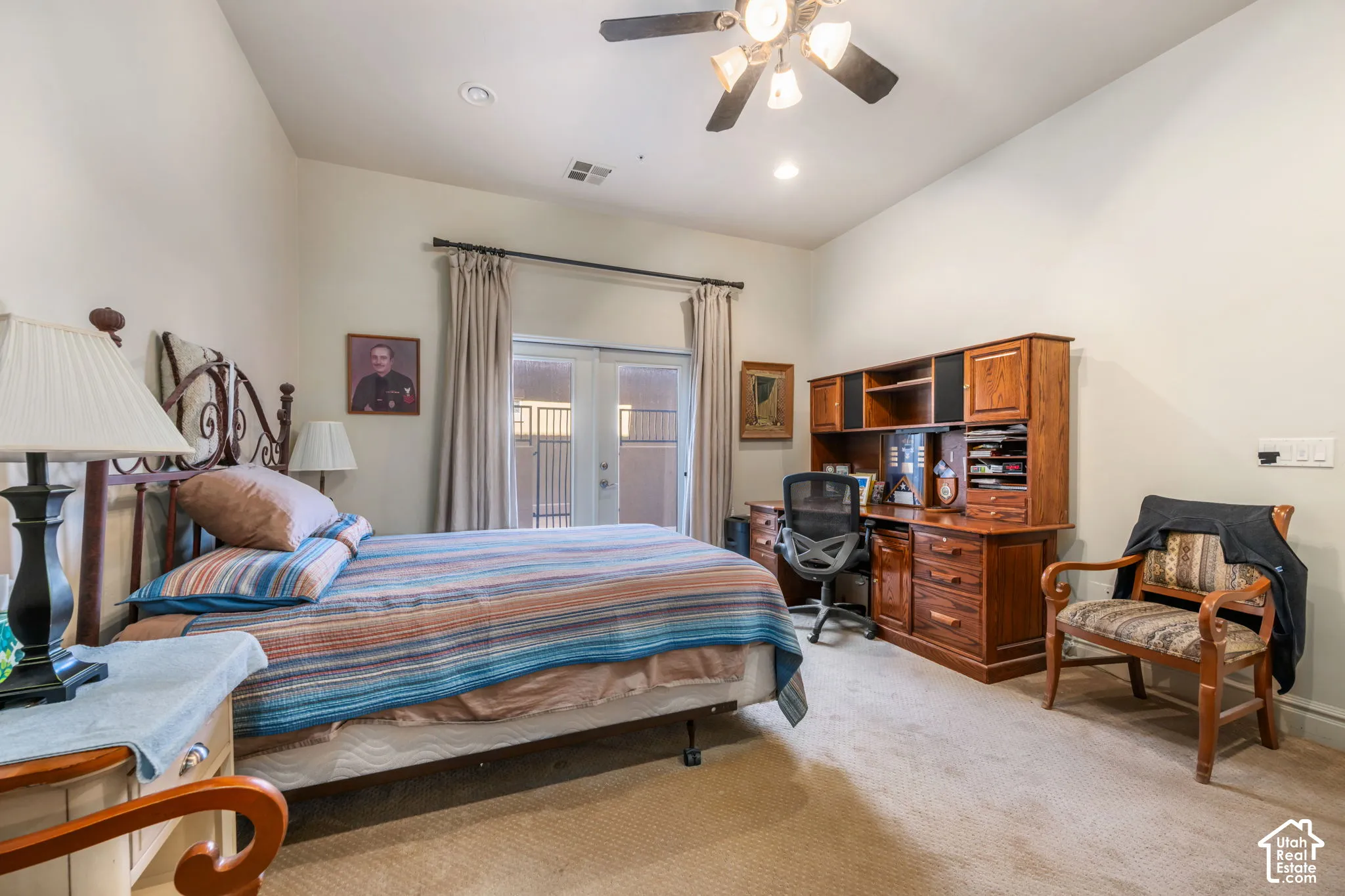 Vaulted ceilings, ceiling fan, recessed lighting, double French doors, wood-finish built-in desk