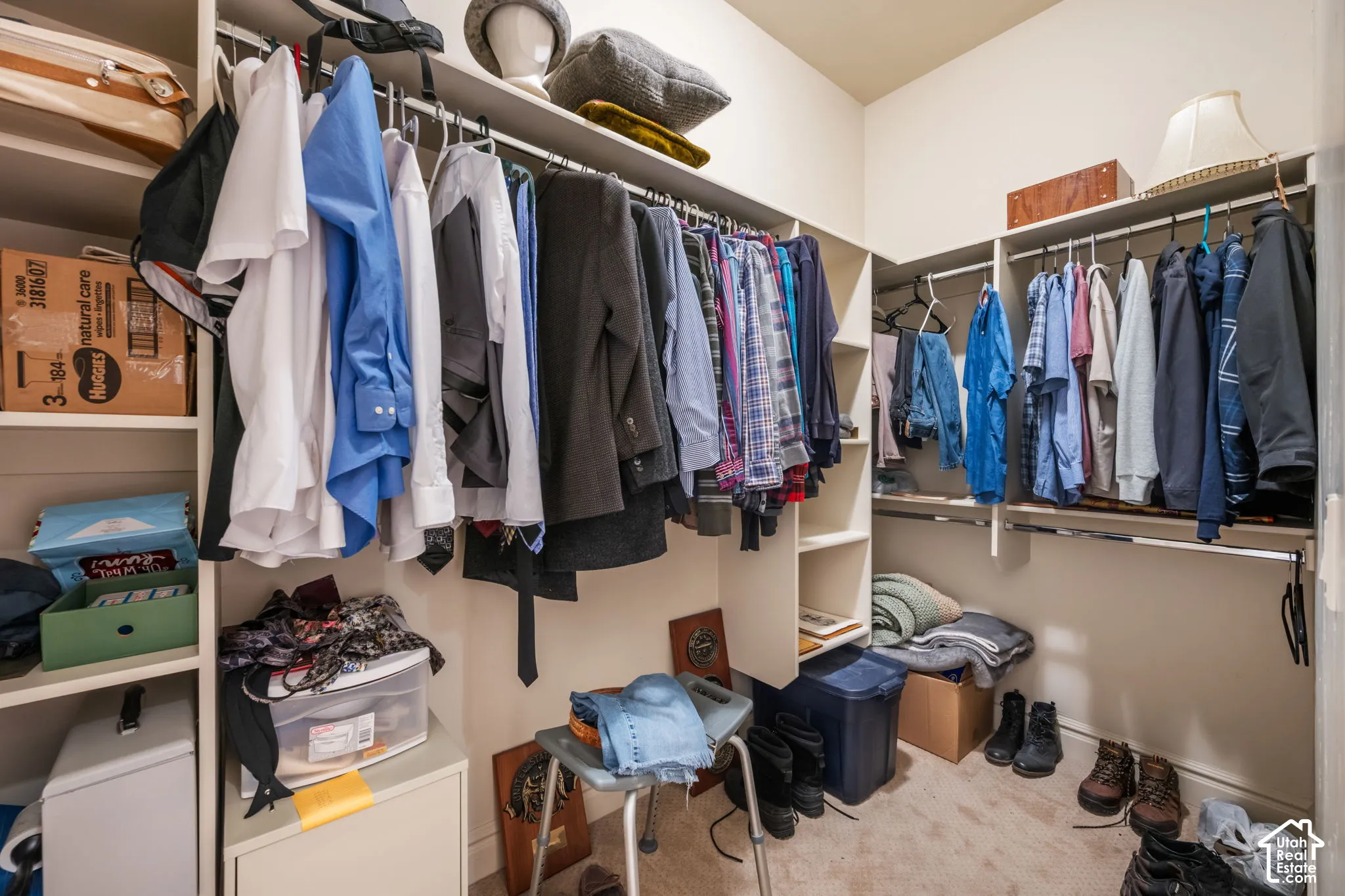 Custom closet system featuring multiple hanging rods and integrated shelving units