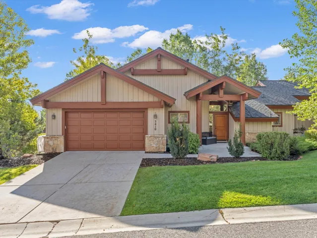 Craftsman-style exterior with wood trim accents and stone detailing