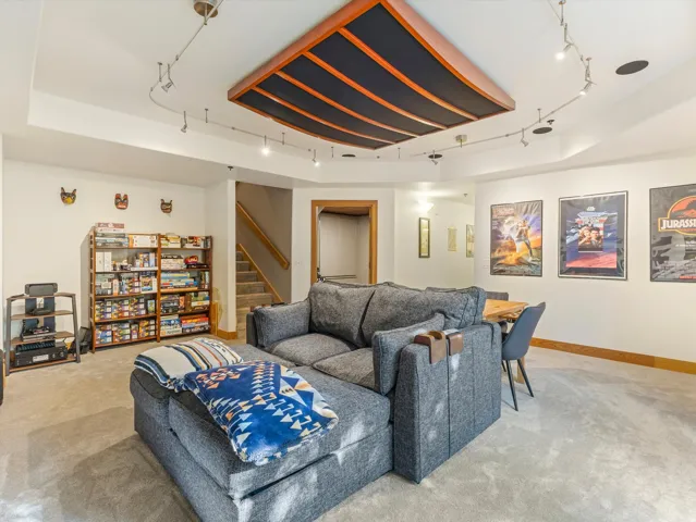 Recessed lighting, track lighting, and a wood-finish ceiling panel