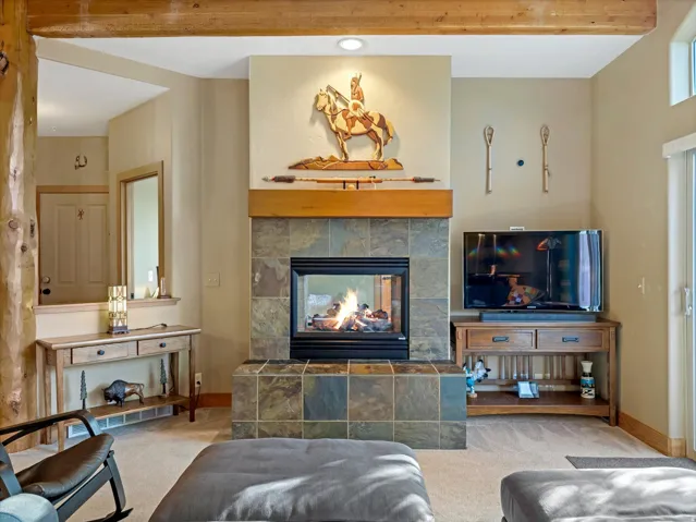 Central fireplace with a tile surround and hearth, featuring a wood mantel
