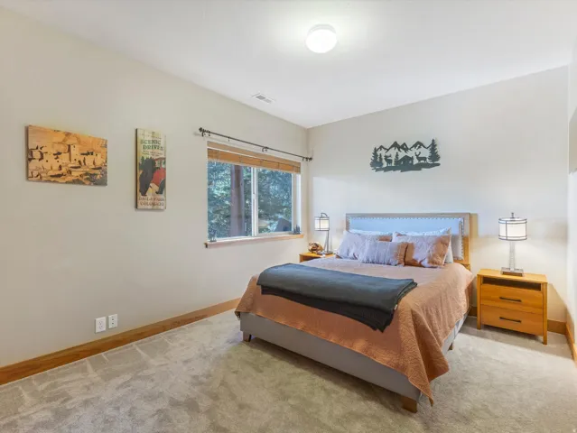Recessed window with wood trim, light-toned walls, and neutral carpeting