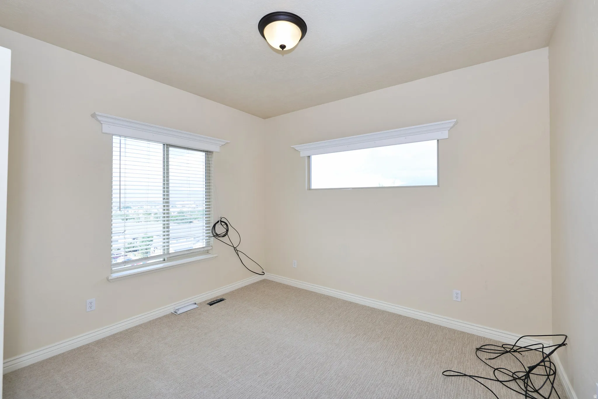 Neutral-toned walls with textured carpeting