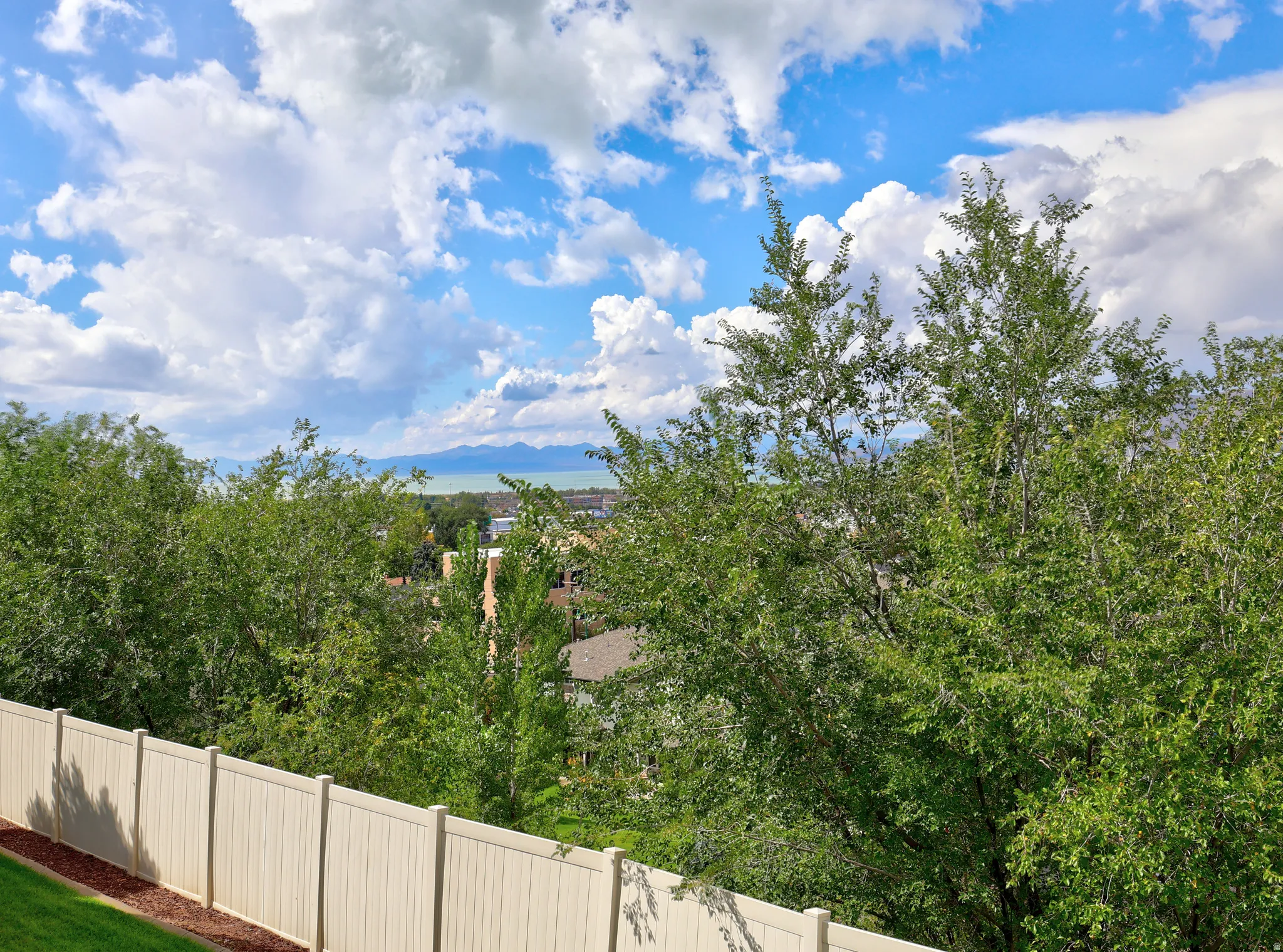 Expansive outdoor scenery with a distant body of water and mountains