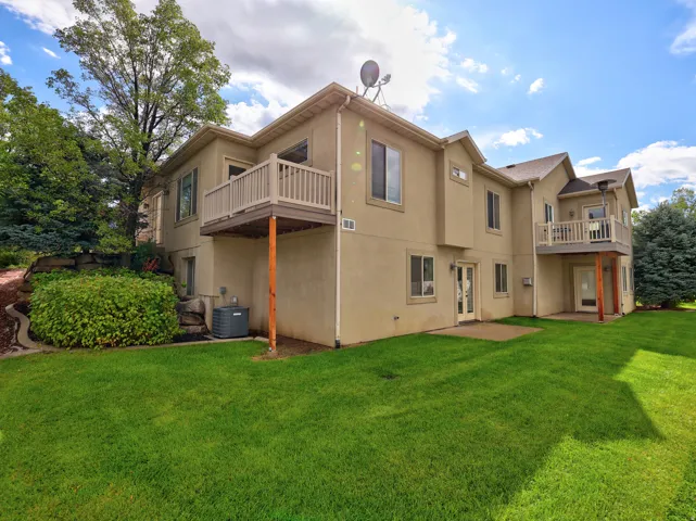 Expansive green lawn with mature trees and established landscaping