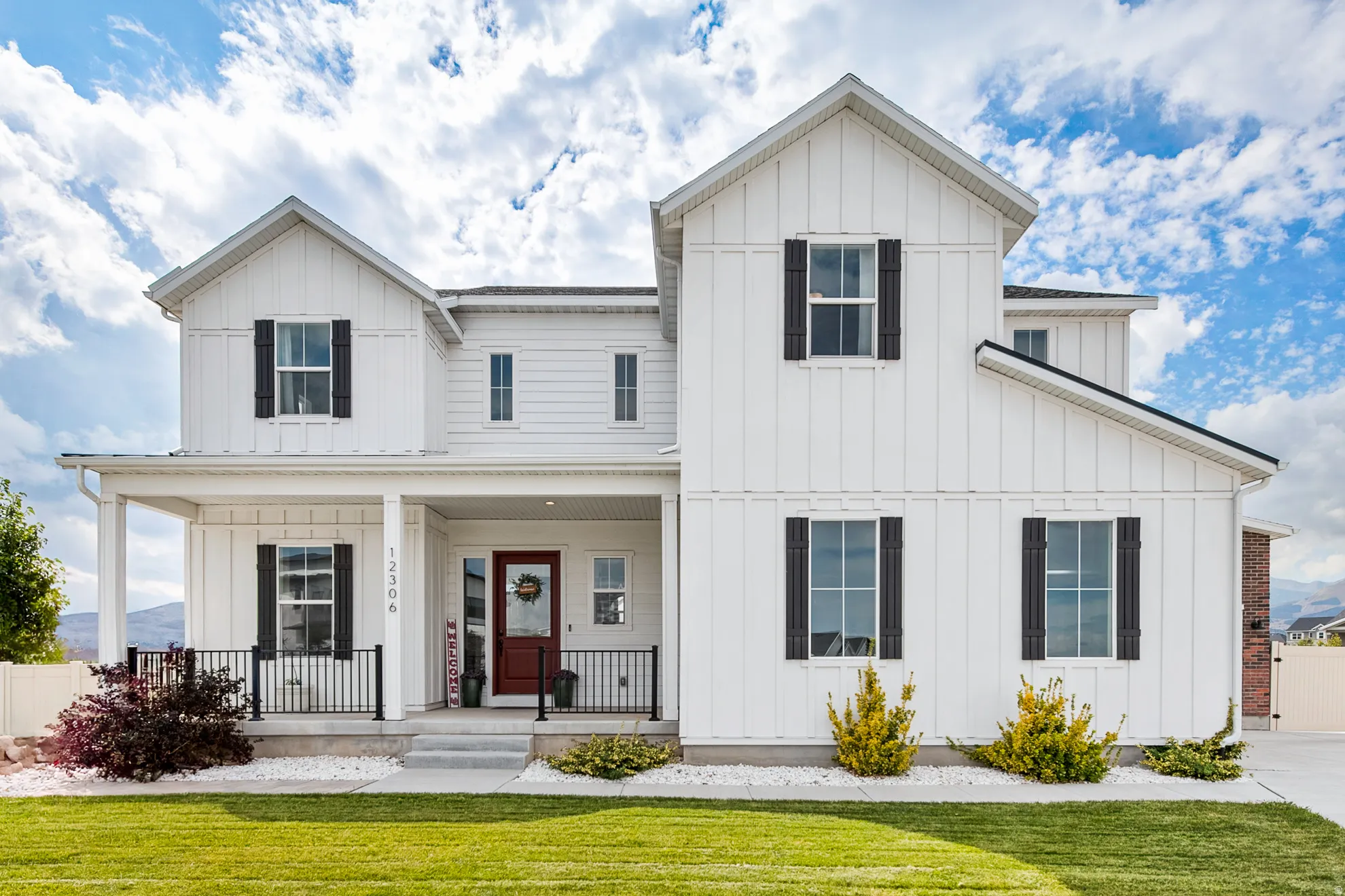White board-and-batten exterior with contrasting dark shutters