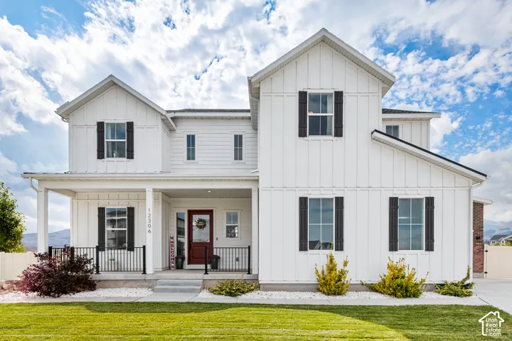 White board-and-batten exterior with contrasting dark shutters