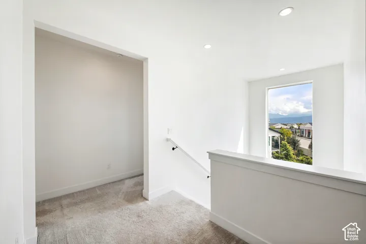Recessed lighting, white walls, and a contemporary railing design
