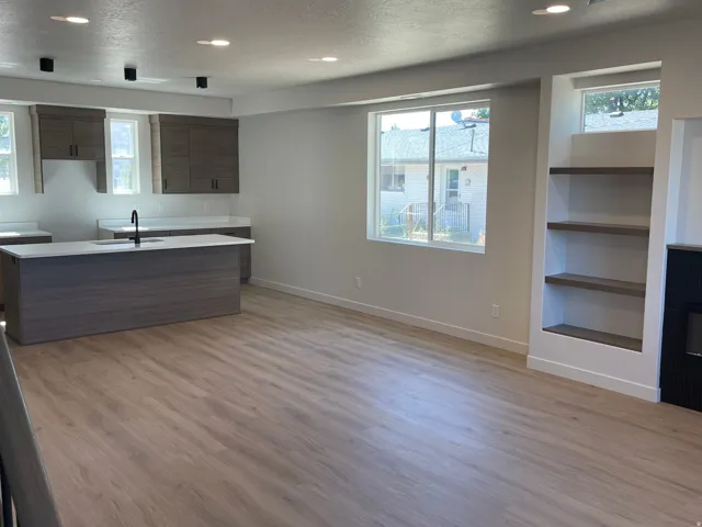 Neutral color palette throughout, featuring light wood-finish flooring