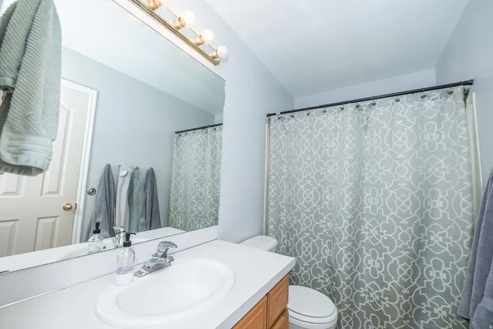 Bathroom vanity with an integrated sink, polished chrome faucet, and a wall-mounted mirror