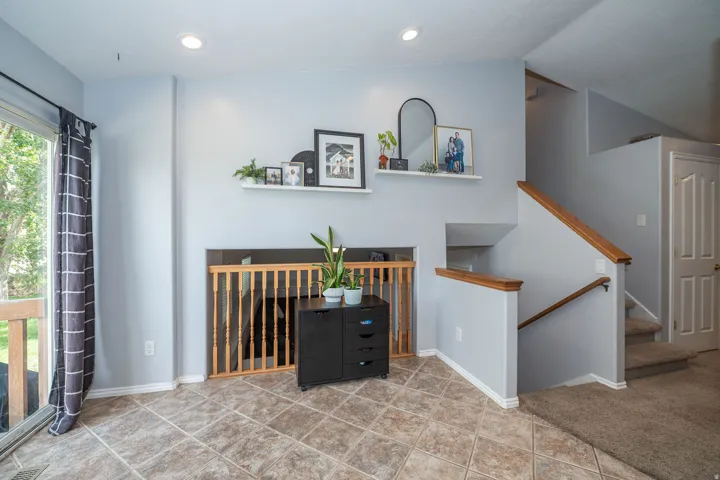Tiled flooring, recessed lighting, and a sliding glass door to your backyard. Open concept looking down to your basement living room.
