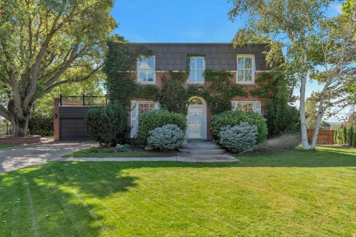 Brick exterior with climbing ivy and white window shutters